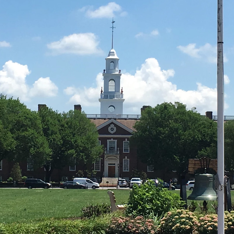 Legislative Hall on a bright sunny day surrounded by trees.