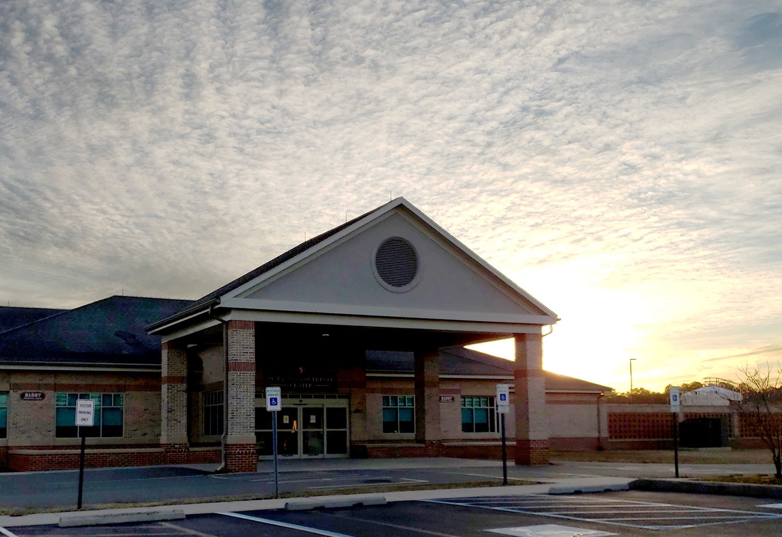Entrance of the Stockley Center with the sun setting behind it.
