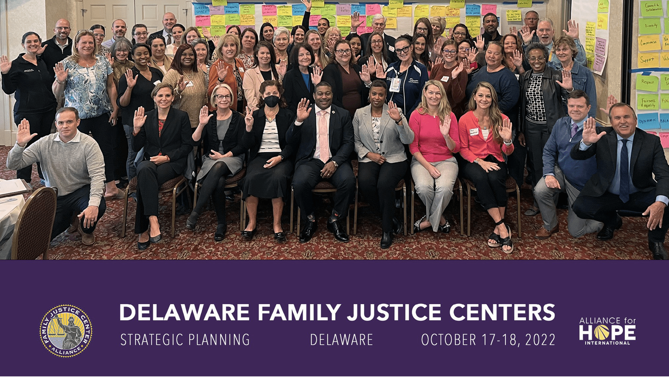 Group photo of the members of the Family Justice Center Alliance waving and smiling to the camera.